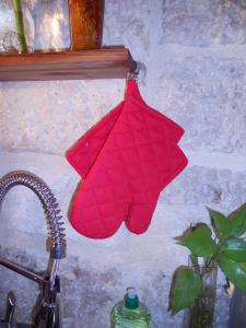 a red towel hanging on a wall next to a sink at Coeur de Provence STC in Avignon
