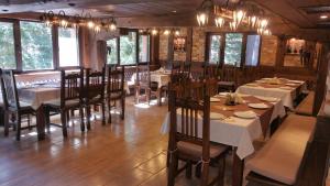 a restaurant with tables and chairs in a room at Hunting Residence Lodge in Panichishte