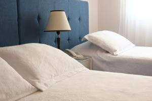 Cama ou camas em um quarto em Hotel San Martin