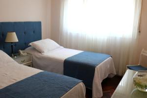 Cama ou camas em um quarto em Hotel San Martin