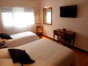 Cama ou camas em um quarto em Hotel San Martin