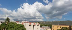 a group of buildings in a city under a cloudy sky at Cozy Accommodations in Kingston