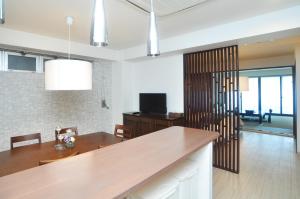 a living room with a table and a dining room at guest house Sakura in Osaka