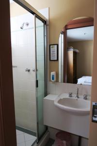 a bathroom with a sink and a shower at Sundeck Hotel in Perisher Valley