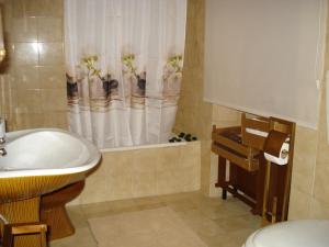 a bathroom with a sink and a tub with a shower at Casa da Avó Teresinha in Sabugueiro +105 photos