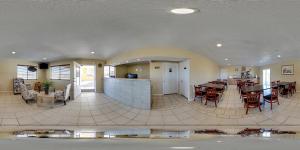 
a kitchen with a lot of white cabinets and a large window at Econo Lodge I-40 Exit 286-Holbrook Holbrook in Holbrook
