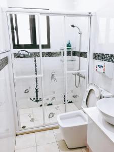 a bathroom with a shower and a toilet and a sink at 木子家民宿 in Magong +28 photos