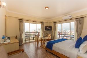 Postel nebo postele na pokoji v ubytování Hotel White Pearl