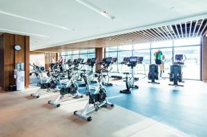 a gym with a bunch of treadmills and ellipticals at The Stanley Hotel & Suites in Port Moresby