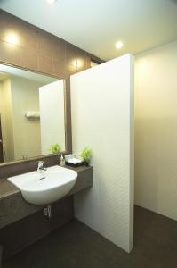 
a bathroom with a sink and a mirror at PS Hill Resort - SHA Plus in Patong Beach
