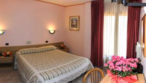 Postel nebo postele na pokoji v ubytování Hotel Les Saisons