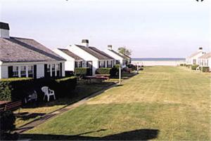 a row of houses on the beach with the ocean at Kalmar Village & Tradewinds in North Truro