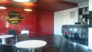 a restaurant with two tables and a large barrel at Idea Hotel Milano Malpensa Airport in Case Nuove