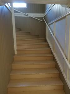 a set of stairs in a basement with a light at Kopparstugans Bed & Breakfast in Falun