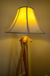 a wooden lamp with a shade on top of it at Hotel Vila Imperial in Elbasan