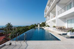 an image of a swimming pool in a building at Sunset Sea View Apartment in Bang Rak Beach