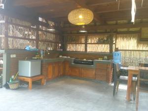 a kitchen with a counter and a sink and a table at Uma Nirmala Aling-Aling in Singaraja
