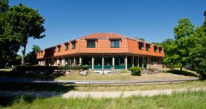 a large house with an orange roof at Nationalparkhotel Kranichrast in Schwarzenhof