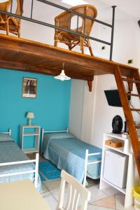 a room with two bunk beds and a staircase at Casa Vacanza Porto Frailis già Porto Frailis B&B in Àrbatax