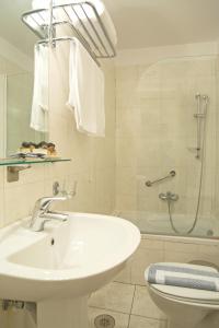 a bathroom with a sink and a shower and a toilet at Hotel Leto Delphi in Delphi