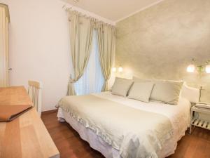 a bedroom with a white bed and a window at Hotel Marina in Monterosso al Mare