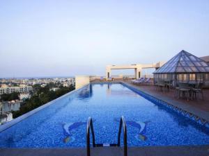 a large swimming pool on the roof of a building at Shenbaga Hotel And Convention Centre in Pondicherry