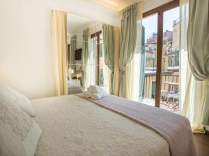 a bedroom with a large bed and a large window at Hotel Marina in Monterosso al Mare