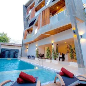 a house with a swimming pool and a dining area at Lemonade Phuket Hotel -SHA Plus in Chalong