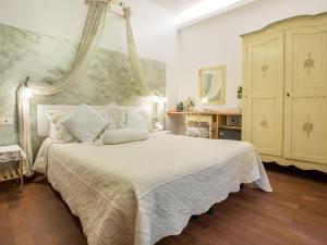 a bedroom with a large white bed with a canopy at Hotel Marina in Monterosso al Mare