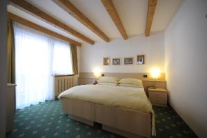 Postel nebo postele na pokoji v ubytování Alpstyle Hotel Albolina Wellness & Beauty