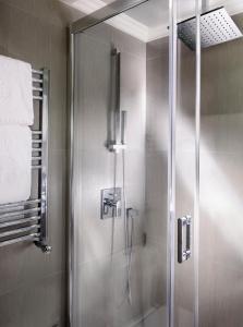 a shower with a glass door in a bathroom at Splendid Etoile in Paris