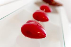 a group of red cherries on a white plate at Suite Home Milano Brera in Milan