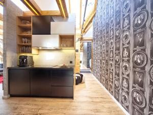 a kitchen with a wall covered in plates at VisitZakopane - Mont Blanc Apartment in Zakopane