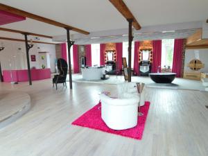 a living room with a pink rug and a room with a table at Lush Apartment in Ensival with sauna in Ensival