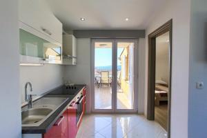a kitchen with a view of the ocean at Apartments VALL in Krk