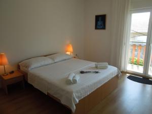 a bedroom with a bed with two towels on it at Modern Apartment in Knin with Garden in Knin