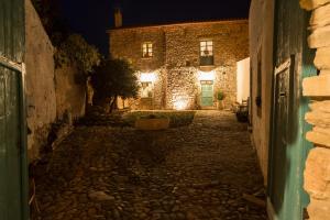 an alley at night with a stone building at Cortis Antigas in Gesturi