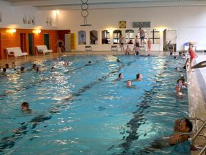 a group of people swimming in a swimming pool at Bungalow im Feriendorf Uslar mit Gartenterrasse in Uslar +28 photos