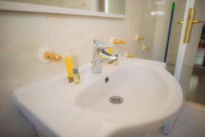 a white bathroom sink with a faucet on it at Apartments Kike&Ana in Split