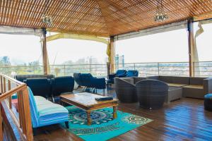 a room with chairs and a table and a couch at Urban by CityBlue Kigali in Kigali