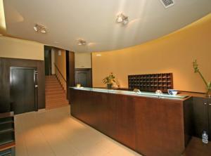 a hotel lobby with a reception counter and stairs at Albergue O Cruceiro in Caldas de Reis