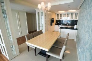 a dining room with a wooden table and chairs at Haeundae Bada Condo in Busan