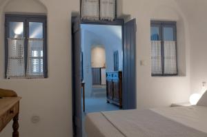 a bedroom with a bed and a hallway at Olyra Traditional Cave Houses in Pirgos