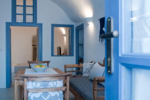 a living room with a table and a couch at Olyra Traditional Cave Houses in Pirgos