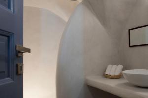 a bathroom with a sink and a bowl on a counter at Olyra Traditional Cave Houses in Pirgos +43 photos
