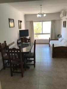 a living room with a desk and a bed at Amoblados Neuquen ALTO COMAHUE SHOPPING in Neuquén