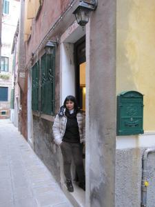 Una donna in piedi sulla porta di un palazzo di Ca' Malatin a Venezia