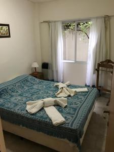 a bedroom with a bed with towels on it at Amoblados Neuquen ALTO COMAHUE SHOPPING in Neuquén