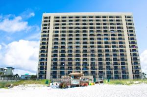 a large building on the beach in front of a building at Sundestin Beach Resort in Destin