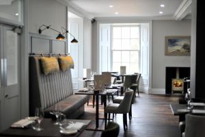 a restaurant with tables and chairs and a fireplace at Marmalade in Portree